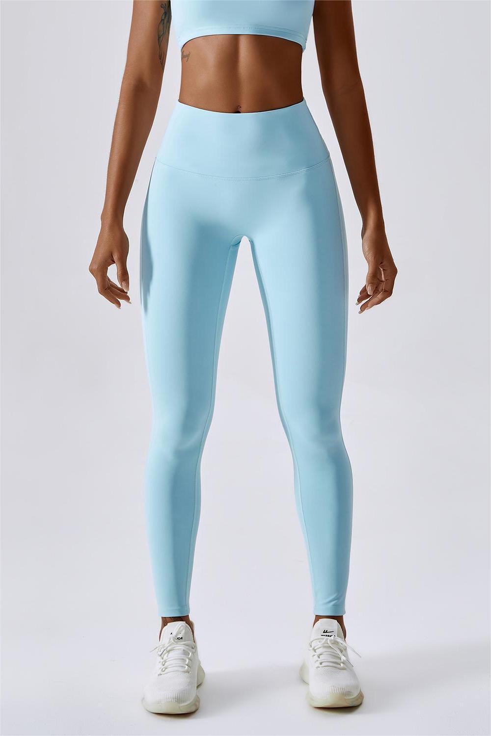 Blue seamless leggings with shaping effect and slits along the length